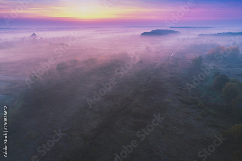 Early foggy morning. Aerial view of countryside and country road