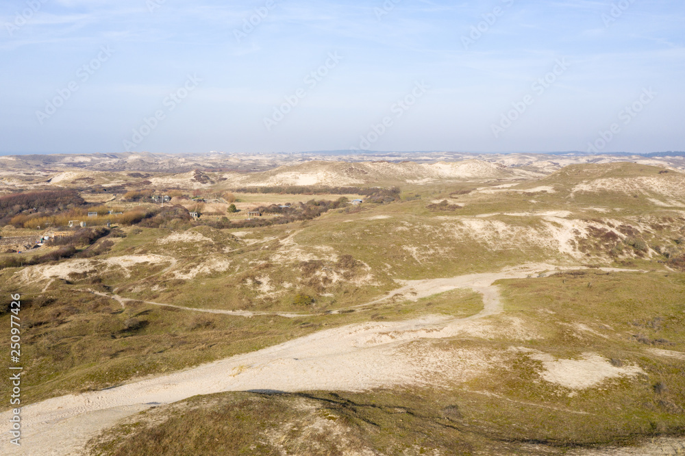 Dutch dunes by the sea from above in mystical late afternoon sun Dutch dunes by the sea from above in mystical late afternoon sun
