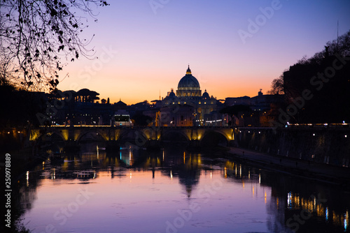 view from the tiber river of St. Peter's Basilica at sunset, Vatican, Rome, Italy