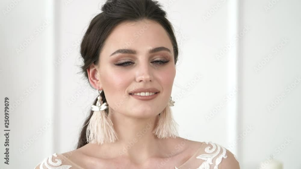 Close up portrait of attractive woman smiling brunette. Emotions of a beautiful girl with fashionable modern makeup Close up portrait of attractive woman smiling brunette. Emotions of a beautiful girl with fashionable modern makeup