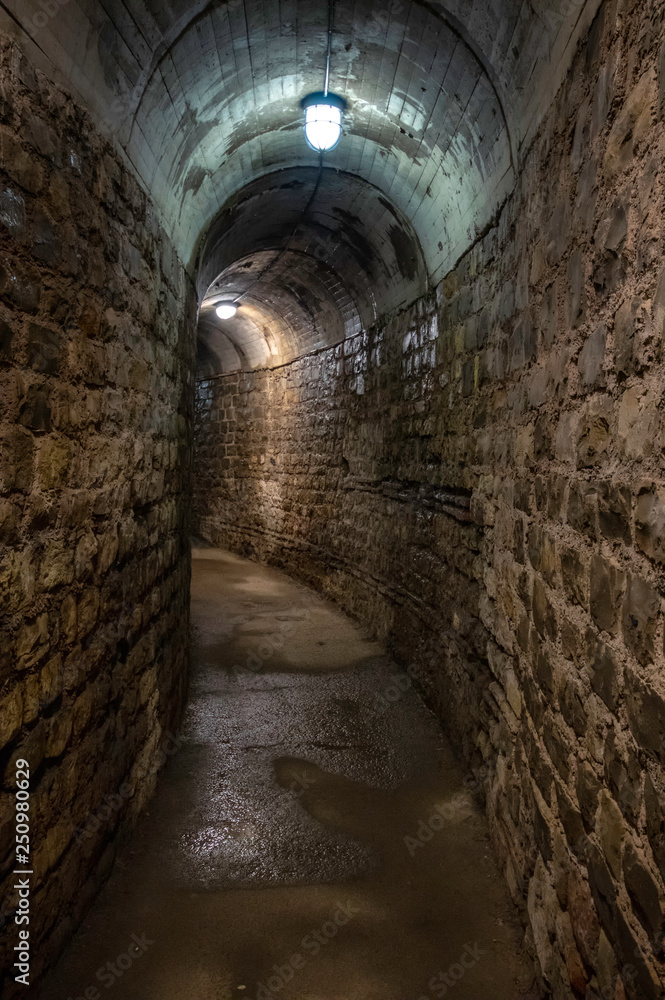 An ancient underground tunnel with lights 