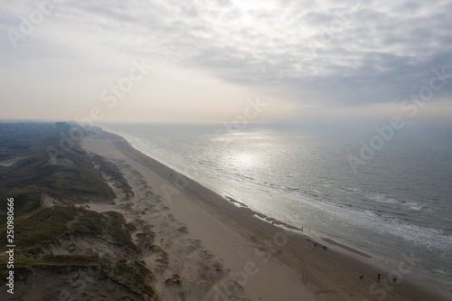 Dutch dunes by the sea from above in mystical late afternoon sun