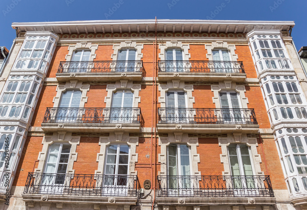 Historic facade of a orange brick building in Burgos, Spain