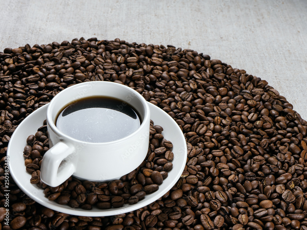 Fototapeta premium Coffee cup and beans on old kitchen table.