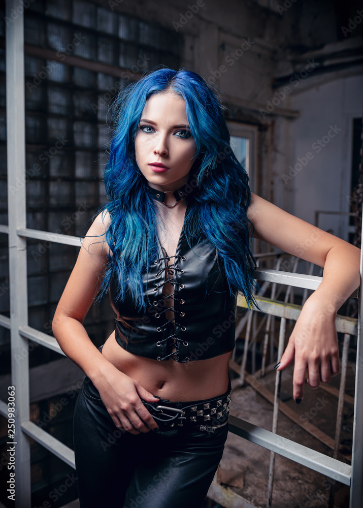 Portrait of lovely rock girl with blue hair (informal model), dressed in  black leather pants and topic Stock Photo | Adobe Stock