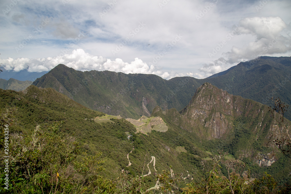 Naklejka premium Machu Picchu and Huayna Picchu mountain in Peru, seen from the door of the sun
