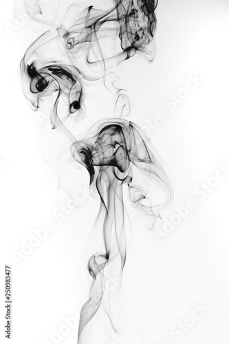 Abstract black smoke swirls and curves on white background