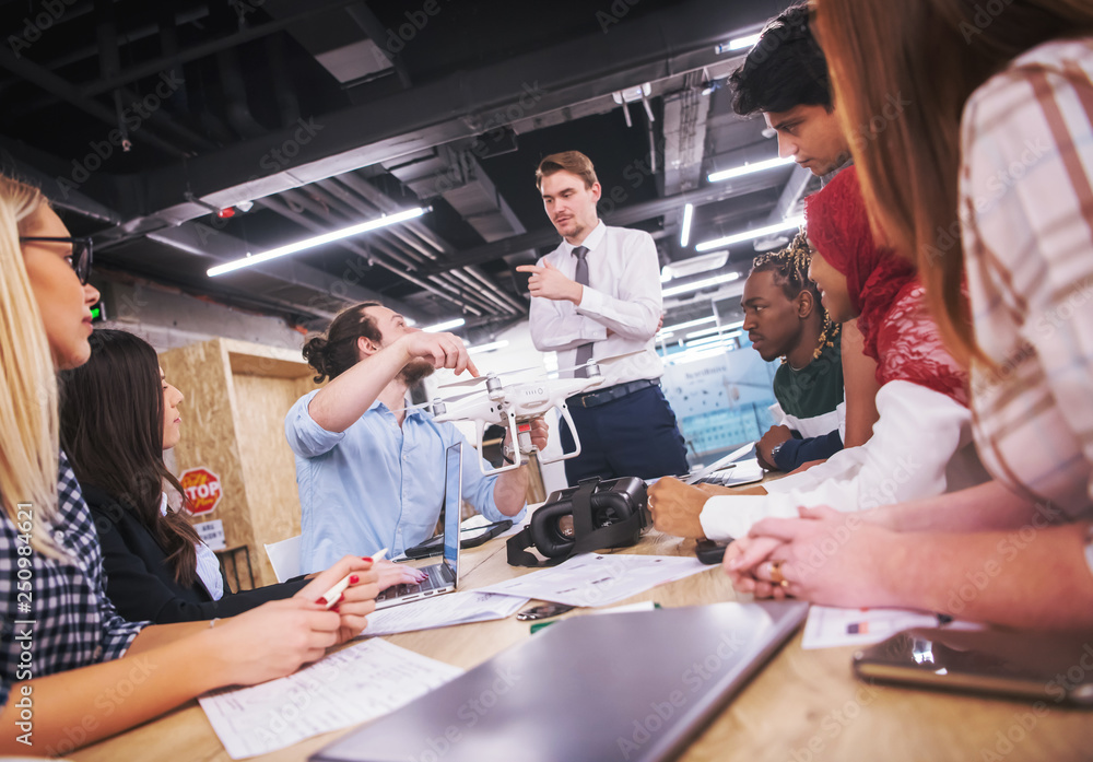 Obraz premium multiethnic business team learning about drone technology