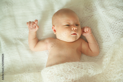cute newborn baby sleeping covered with fluffy blanket.