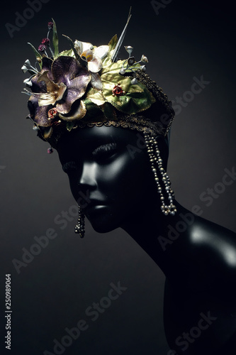 Head of mannequin in creative kokoshnick with flower and leaves