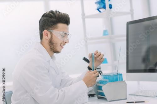 modern scientist examines test tube with liquid