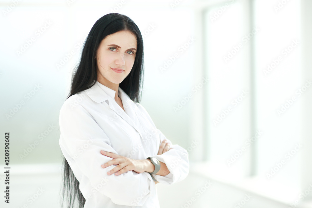 female therapist standing by the hospital window female therapist standing by the hospital window