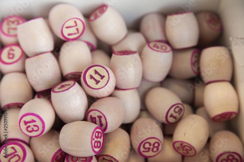 Wooden lottery barrels, lotto  game on table, random pink numbers