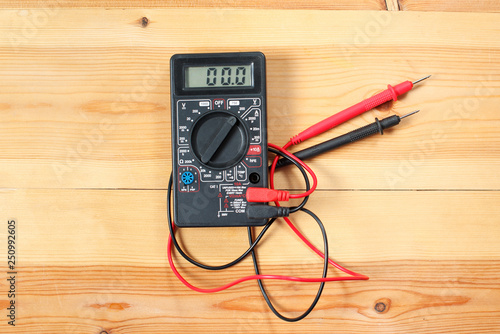 digital multimeter and wiring on wooden table. special tools of technician for work with circuit and electrical. technician use the digital multimeter in workshop for check repair equipment