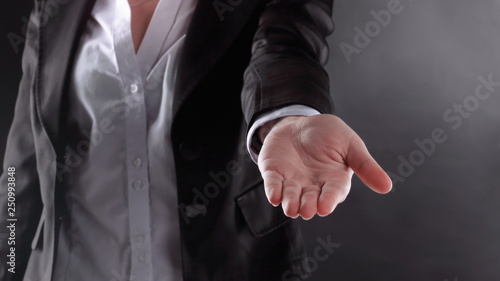 close up. business woman with open palm .isolated on black background