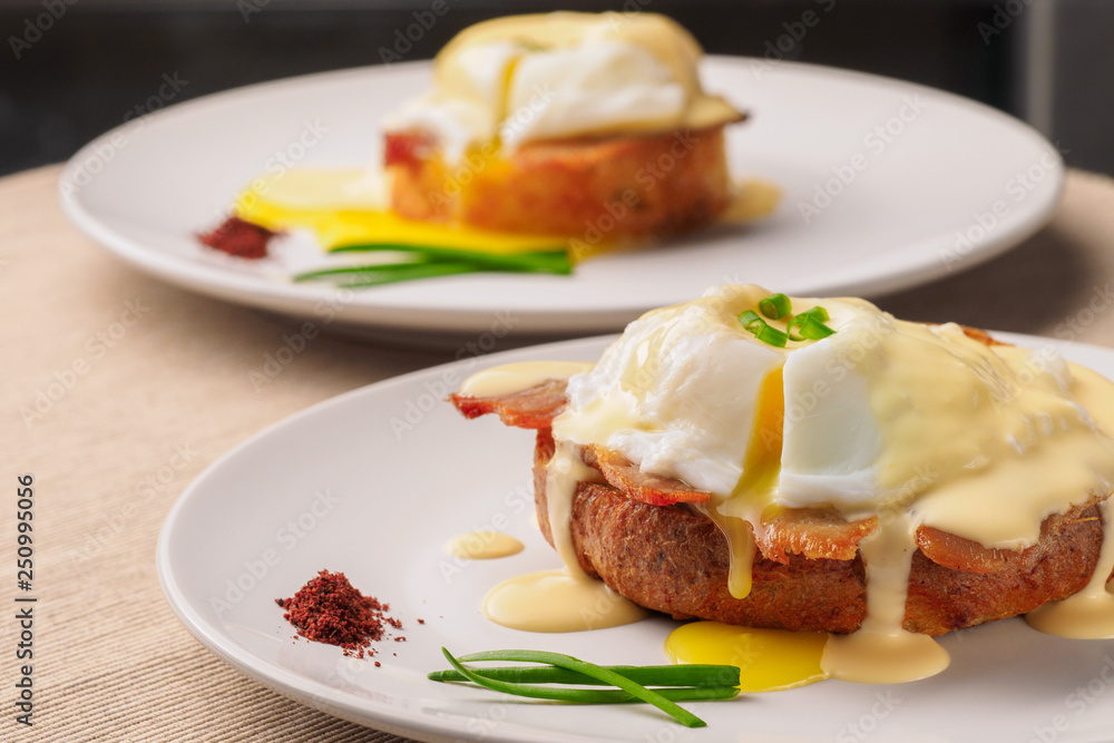 Breakfast is Eggs Benedict - toasted English muffins, bacon, ham, poached eggs, herbs and delicious buttery hollandaise sauce. Breakfast is Eggs Benedict - toasted English muffins, bacon, ham, poached eggs, herbs and delicious buttery hollandaise sauce.