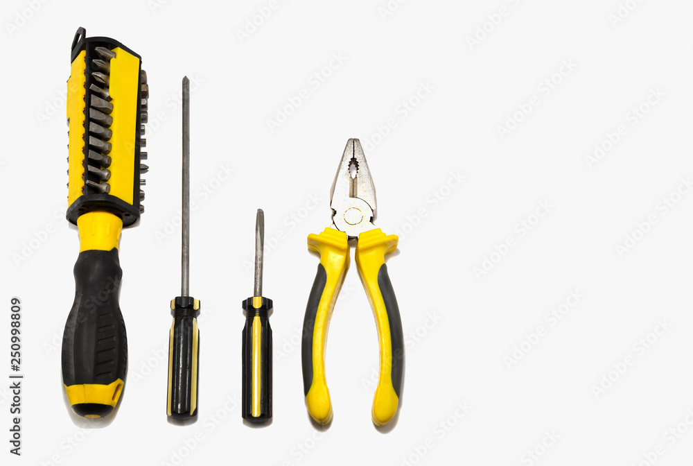 Tools on grey background pliers and screwdrivers. Tools on grey background pliers and screwdrivers.