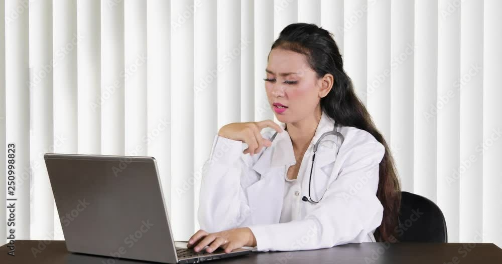 Pretty young female doctor working with a laptop computer and thinking idea. Shot in 4k resolution Pretty young female doctor working with a laptop computer and thinking idea. Shot in 4k resolution