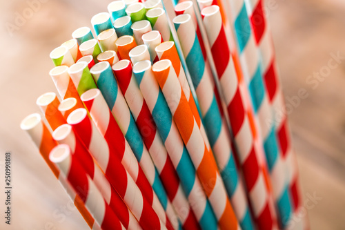 Eco friendly stripped paper straws in a glass, closeup photo