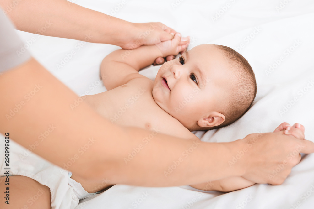 Mother massaging and doing gymnastic to her kid Mother massaging and doing gymnastic to her kid