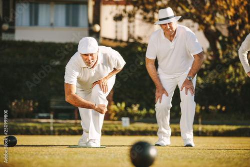 Foto Old men playing a game of boules