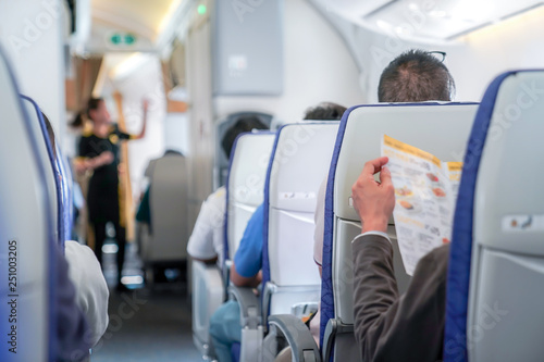 Φωτογραφία somebody read the menu in the plane, ready order to air hostess.