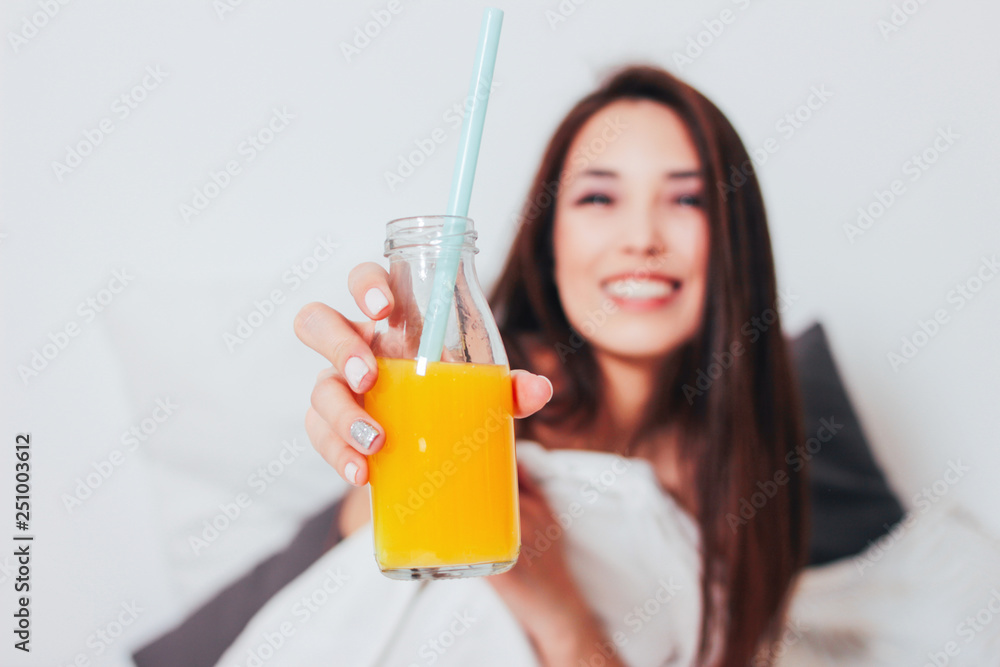Orange juice in glass jar in hand of happy beautiful smiling asian girl young woman, healthy cozy morning Orange juice in glass jar in hand of happy beautiful smiling asian girl young woman, healthy cozy morning