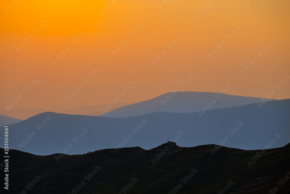 mountain ridge silhouette in a mist at the twilight