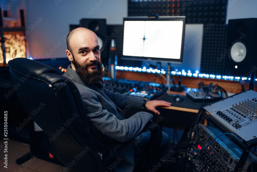 Fototapeta premium Bearded sound engineer in audio recording studio