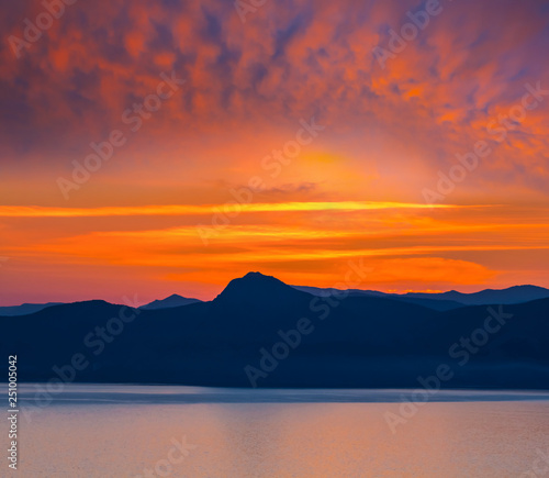 red dramatic sunset over the sea bay