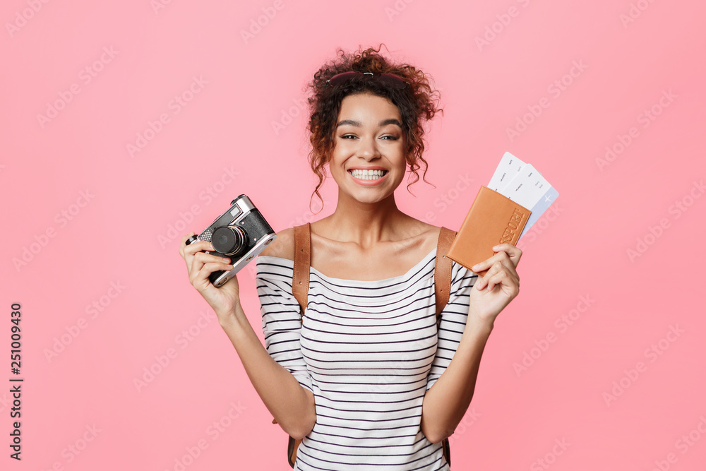 African-american woman holding camera and passport with tickets African-american woman holding camera and passport with tickets