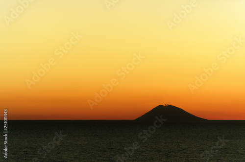 Amazing colorful sunset panorama with silhouette of volcano island Stromboli