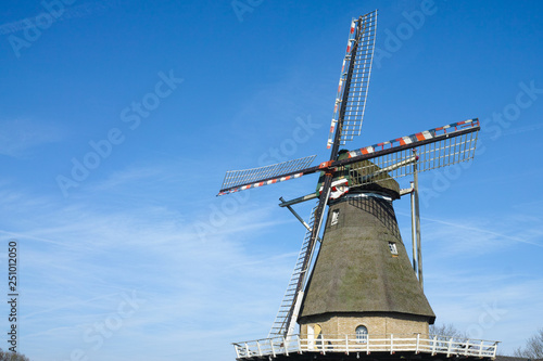 Spring landscape with traditional Dutch windmill in Brabant