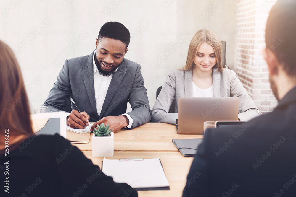Diverse business people working together in office Diverse business people working together in office