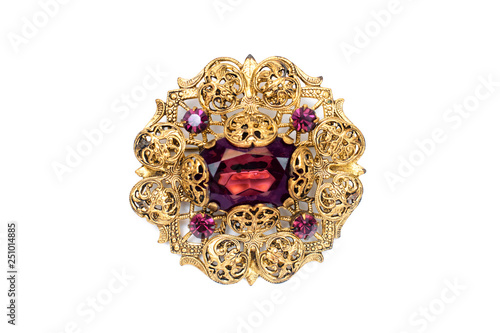 Beautiful antique precious brooch with openwork pattern and stone on white isolated background