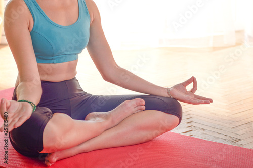 Young caucasian woman doing yoga sitting meditation on the floor. Healthy lifestyle concept. Place for text