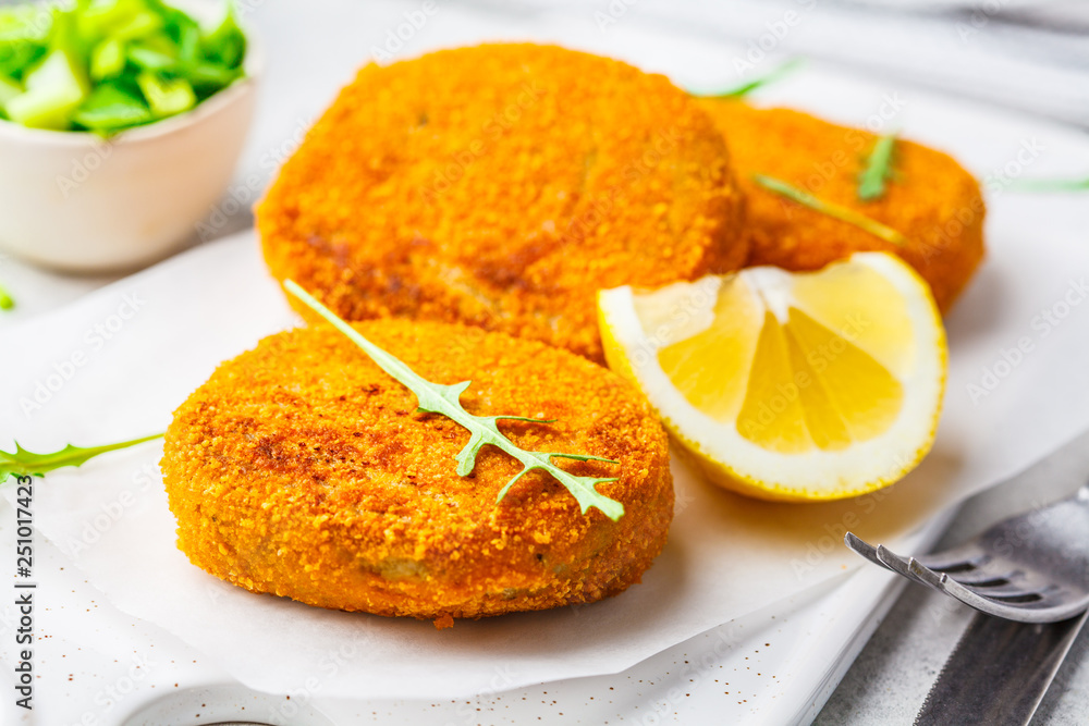 Cooked salmon fish cutlets on white board. Cooked salmon fish cutlets on white board.