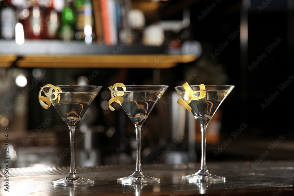 Glasses of lemon drop martini cocktail on bar counter. Space for text Glasses of lemon drop martini cocktail on bar counter. Space for text
