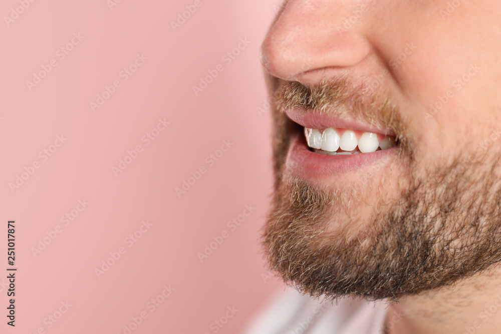 Young man with healthy teeth on color background, closeup. Space for text Young man with healthy teeth on color background, closeup. Space for text