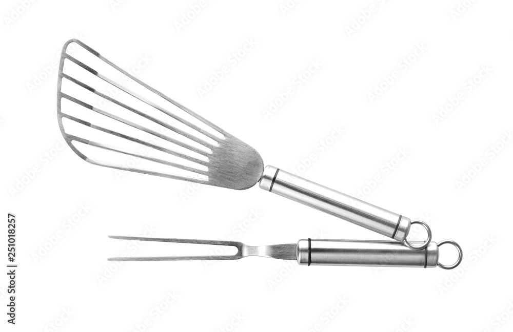 Slotted spatula and meat fork on white background Slotted spatula and meat fork on white background