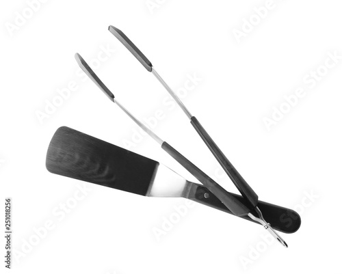 Tongs and spatula on white background. Kitchen utensils