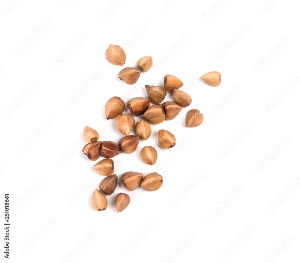 Uncooked buckwheat on white background, top view Uncooked buckwheat on white background, top view