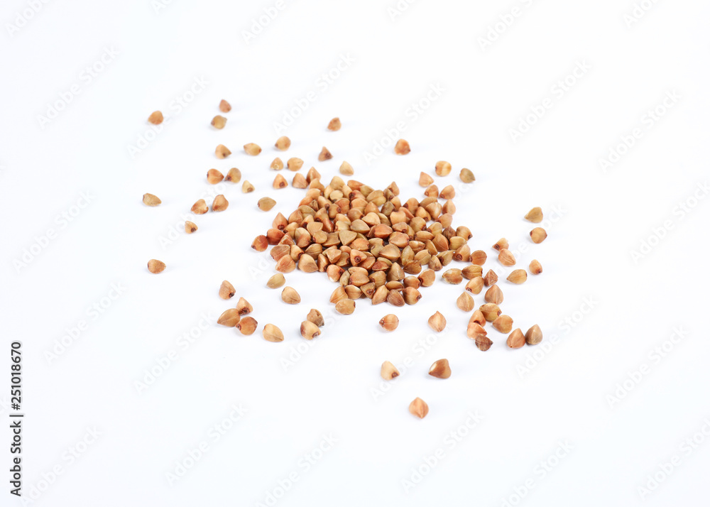 Uncooked buckwheat on white background. Healthy diet Uncooked buckwheat on white background. Healthy diet
