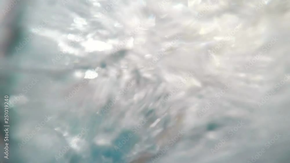young happy man falling in pool under water from water slide in slow motion young happy man falling in pool under water from water slide in slow motion