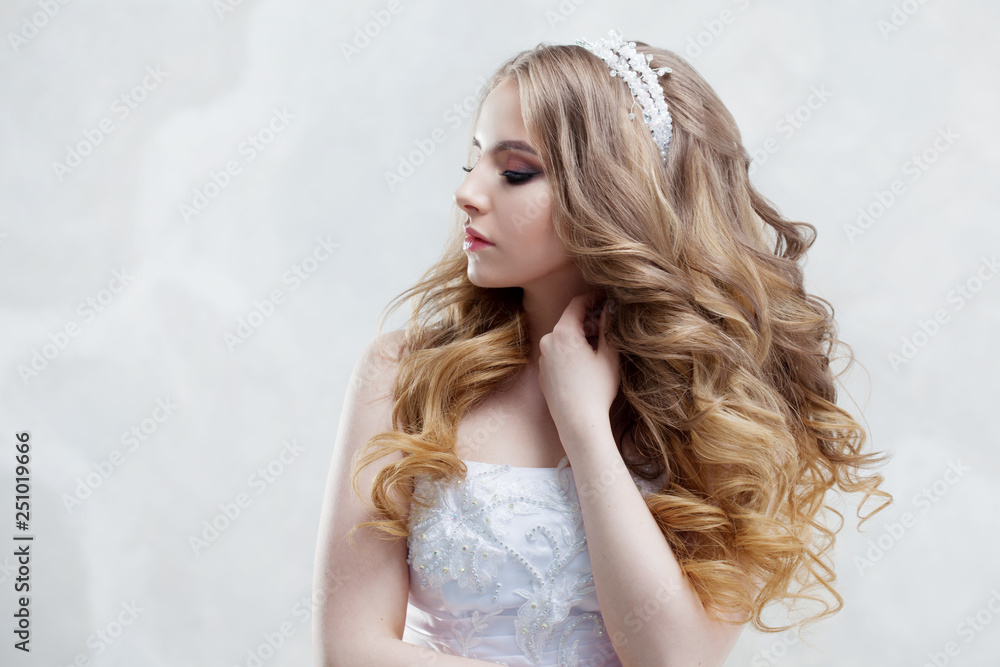 Charming young bride with luxury hairstyle. Beautiful woman in wedding dress. Hairstyle with fluffy curls. Charming young bride with luxury hairstyle. Beautiful woman in wedding dress. Hairstyle with fluffy curls.
