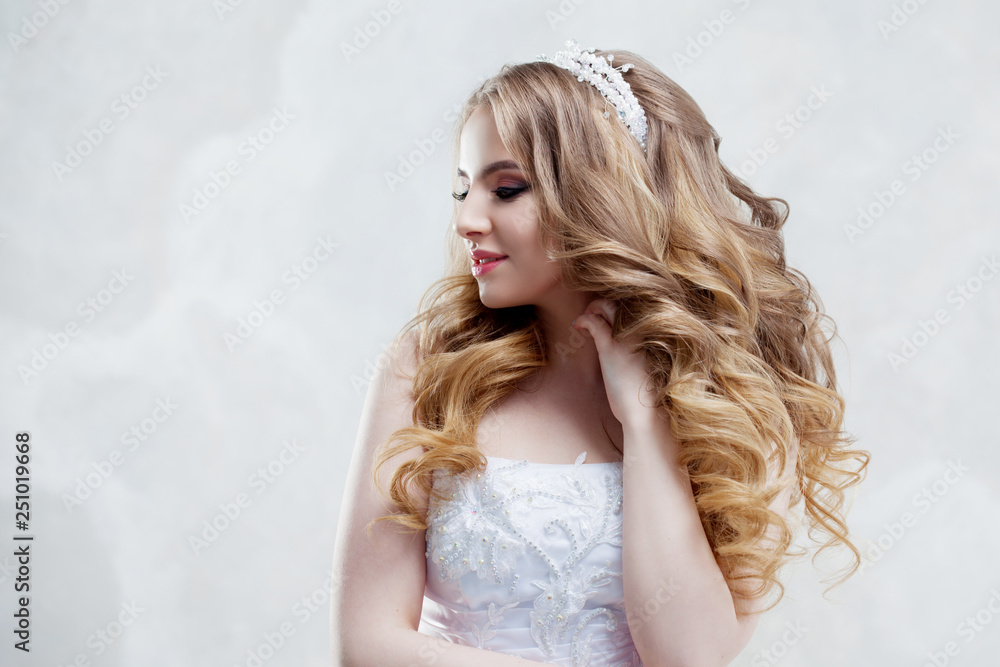 Charming young bride with luxury hairstyle. Beautiful woman in wedding dress. Hairstyle with fluffy curls. Charming young bride with luxury hairstyle. Beautiful woman in wedding dress. Hairstyle with fluffy curls.