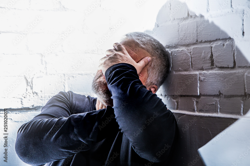 Φωτογραφία a desperate man holds his head with his hands