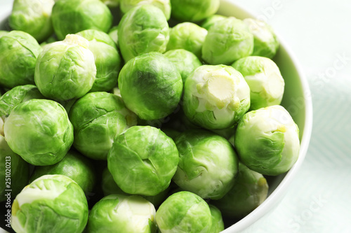 Bowl of fresh Brussels sprouts on table, closeup
