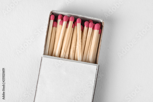 Cardboard box with matches on light background, top view. Space for design