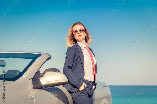 Successful young businesswoman on a beach